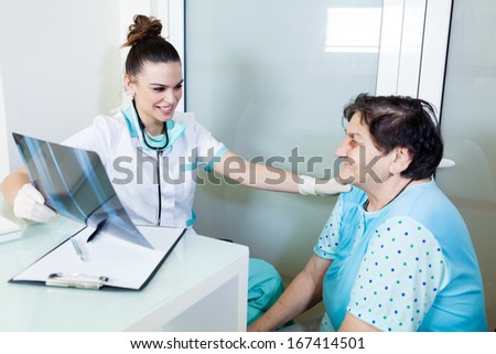 Exam room: Female doctor and patient looking X-ray