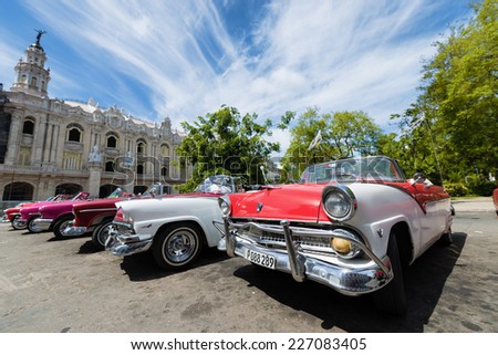 HAVANA, CUBA - OCTOBER 8, 2014: Old classic American cars in street city Havana. Before a new law issued on October 2011, Cubans could only trade cars that were on the road before 1959. Wide angle.