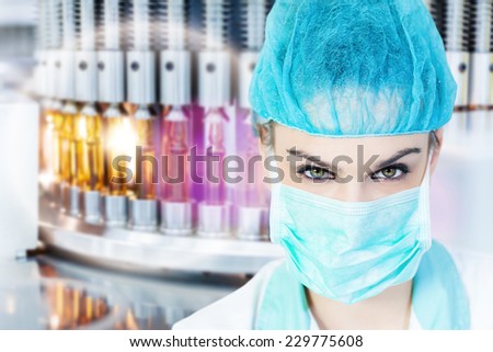Health care worker with a mask in the front of the medical vials