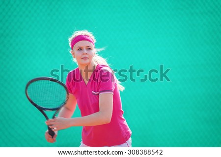 Young, blonde tennis player in a action.Copy space, shallow doff