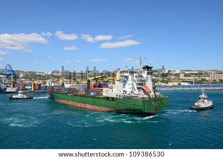 MARSEILLE, FRANCE- 15 JULY: Tug boats assist cargo ship Aggeliki P. on July 15,2012 in Marseille, France.  This port is number one in France and the Mediterranean and number three in Europe