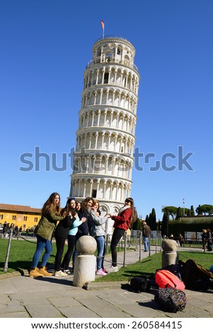 PISA, ITALY - MARCH 06,2015:Tourists posing in front of the Leaning tower of Pisa.