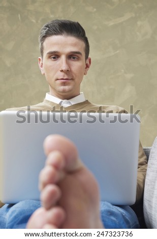 Relaxed man working on laptop