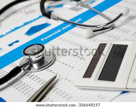 Stethoscope, calculator and financial papers
