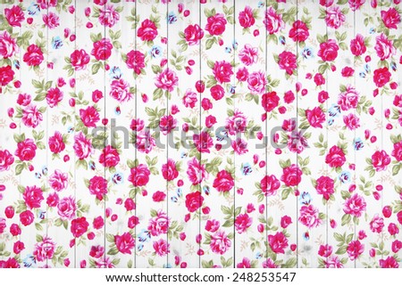 rose vintage from fabric on white wooden background.