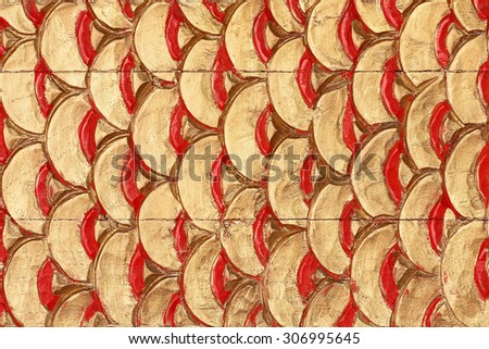 Pattern of dragon scales carved on wood background
