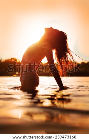 Woman on the beach enjoys the sun