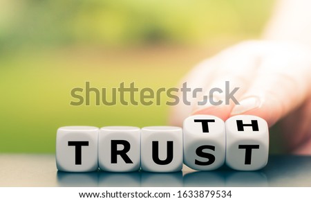 Truth instead of trust. Hand turns dice and changes the word 'Trust' to 'Truth'. Сток-фото © 