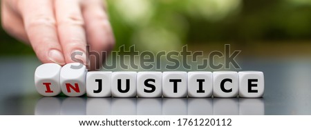 Justice instead of injustice. Finger flip dice and change the word 'injustice' to 'justice'. Foto stock © 