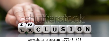 Symbol for a better inclusion. Hand turns dice and changes the word exclusion to inclusion.