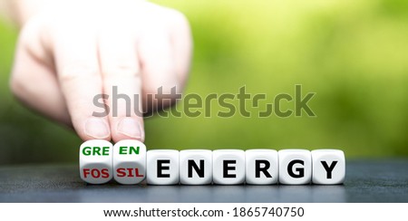 Hand turns dice and changes the expression 'fossil energy' to 'green energy'. Stockfoto © 