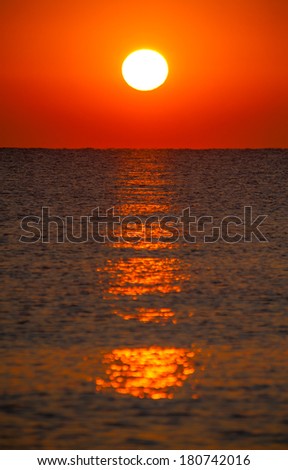 Burning sun on sea horizon