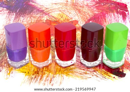 Bottles with spilled nail polish - Stock Image