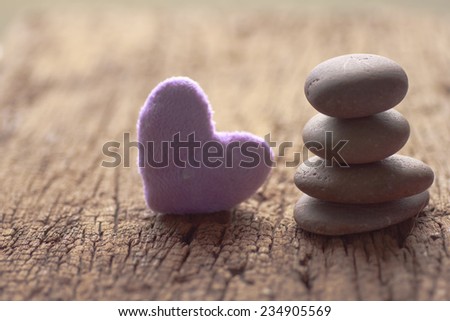 Zen stones and violet Heart on a wooden background, Love vintage concept