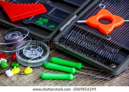 Fishing adventures, carp fishing.A large fisherman's tackle box fully stocked with lures and gear for fishing.installation for carp fishing for big fish.