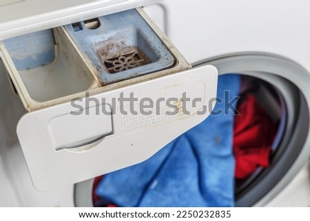 Washing machine.Dirty moldy washing machine detergent and fabric conditioner dispenser drawer compartment close up. Mold and dirt in washing machine. Foto stock © 