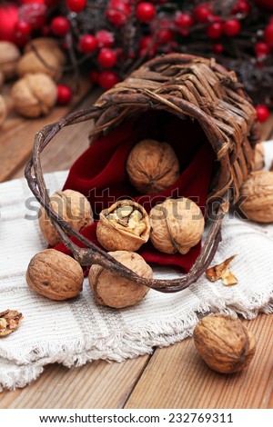 Walnuts in a vintage basket with Christmas background. Russian tradition to eat nuts on Christmas holidays. Selective focus