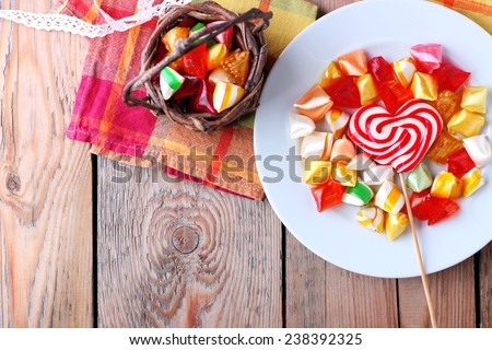 Plate and basket with colorful sweet candies. Copy space background. Selective focus. Traditional candies for Seker Bayram holiday