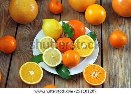Beauty and health, food and drink, diet and nutrition concept. Citrus fruits (orange, lemon, tangerine) on a wooden table. Selective focus, top view
