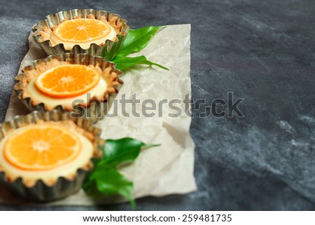 Hand made tart, tartlet with lemon curd on a black background. Selective focus, copy space background
