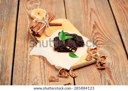 Still life, food and drink, holidays concept. Chocolate bars with cinnamon and walnuts. Selective focus