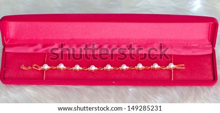 Silver pearl earrings and red velvet box.