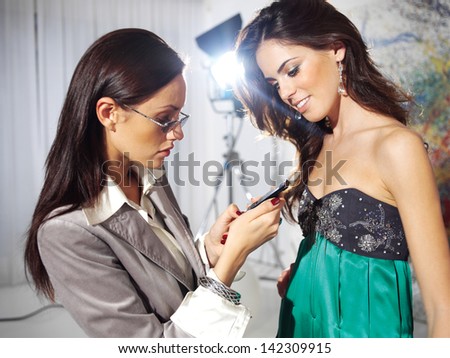 Attractive business women look at face to face