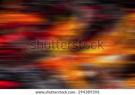 A mix of red, white, black, yellow and orange blurred background.