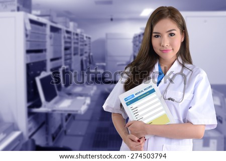 Female doctor with electronic medical record on blue background of computer system.