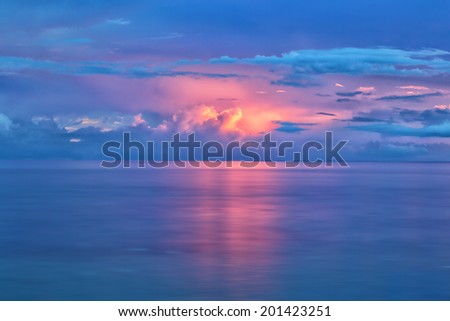 The beautiful colors of the sunset reflecting on the ocean after the storm