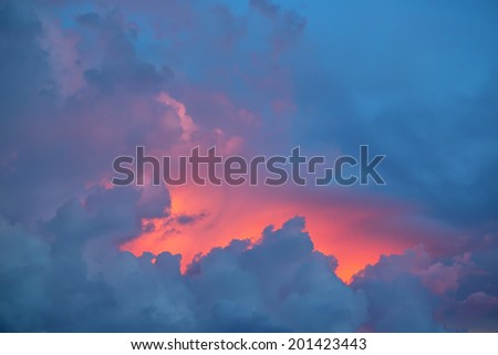 The glow of the sunset behind storm clouds from Guam horizontal image
