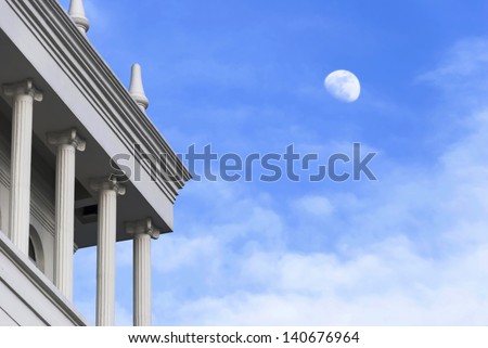 White moon in the blue sky at dusk, classical European-style architecture on the bank of the Songhua River in Harbin, Heilongjiang province, China.