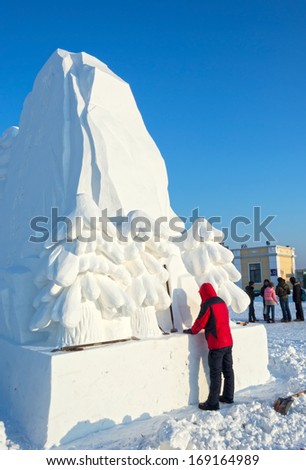 HARBIN, CHINA - DECEMBER 30, 2013: Building snow sculptures. located in Harbin Ice and Snow World. December 30, 2013 in Harbin City, Heilongjiang Province, China.