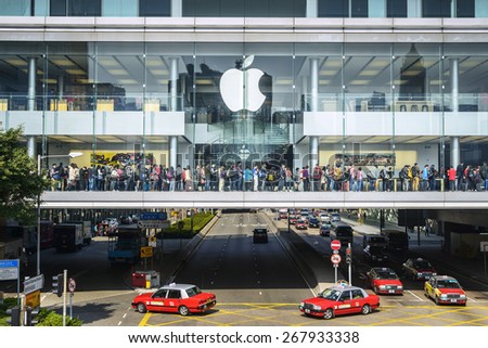 Hong Kong - February 13, 2015: Apple Retail Stores. Shoppers trying out Apple products and shopping. Located in International Finance Centre, Central, Hong Kong.