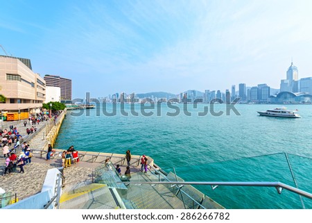 Hong Kong - February 8, 2015: Victoria Harbour and Avenue of Stars. People are walking. Taken from Avenue of Stars. Located in Hong Kong.