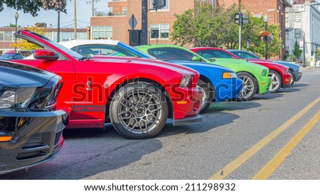FERNDALE, MI/USA - AUGUST 16, 2014: Six Ford Mustang cars at Mustang Alley, at the Woodward Dream Cruise. The Dream Cruise is the world\'s largest one-day automotive event. National Scenic Byway