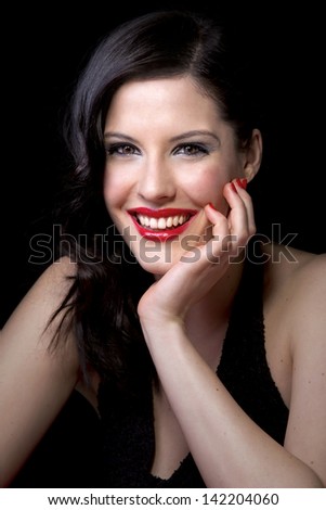 beautiful teeth and uses red nail polish and lipstick