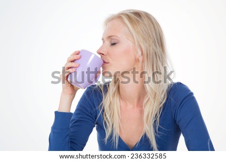 sensual girl drinks delicious infusion - profile of woman with long and blond hair