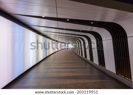 LONDON, UK - JULY 4, 2014: New pedestrian tunnel with integrated lightwall has opened at King\'s Cross Rail Station.