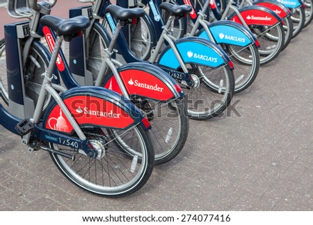 LONDON, UNITED KINGDOM - APRIL 30, 2015: Cycle hire docking station with new bikes sponsored by Santander who are replacing Barclays as main sponsor.