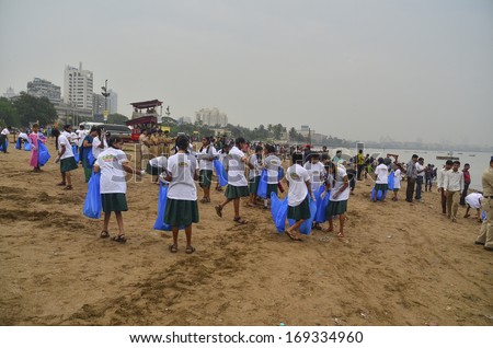 Mumbai, India - September 2013 - Volunteers helping to clean up the beach during the rain after the immersion of Hindu God Ganesha