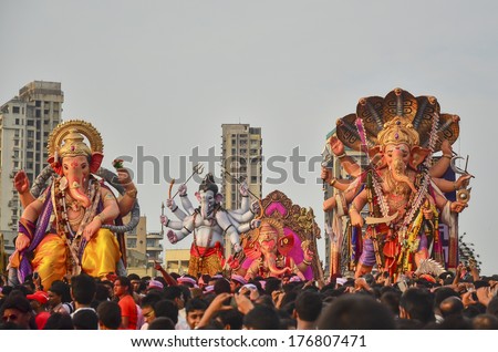 Mumbai, India - September17, 2013 - Devotees bringing Hindu God Ganesha into the ocean during Ganesha Festival at Chowpatty Beach of South Mumbai