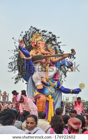 Mumbai, India - September 17, 2013 - Devotees bringing Hindu God Ganesha into the ocean during Ganesha Festival