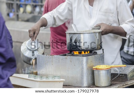 Man selling Indian milk tea on a pavement near Colaba of South Mumbai India