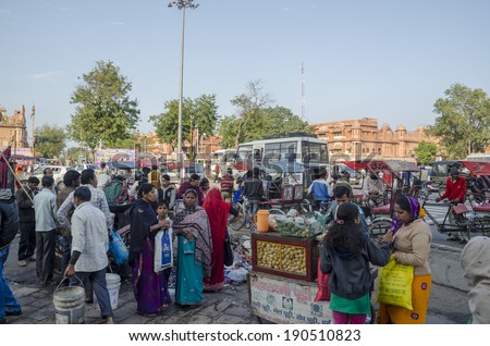 Jaipur, India - February 27, 2014 - Local people buying snacks at local market during daytime