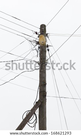 wooden pole with an old lantern and a plurality of wires