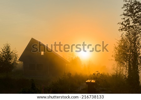 the sun early in the morning rises over a lodge