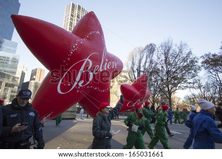 NEW YORK CITY, NY - NOVEMBER 28: Believe Star, final balloon in parade, flying through W 59th ST during the Macy\'s 87th Annual Thanksgiving Day Parade on November 28, 2013 in New York City, New York.