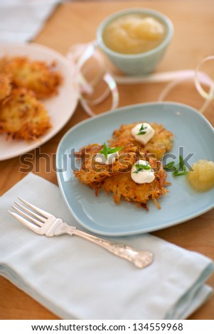 Latkes, or potato pancakes, served with onions, sour cream and applesauce, commonly served at Hanukkah.