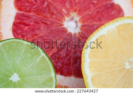 Fresh colorful tropical fruits and slices - lemon, lime, red grapefruit